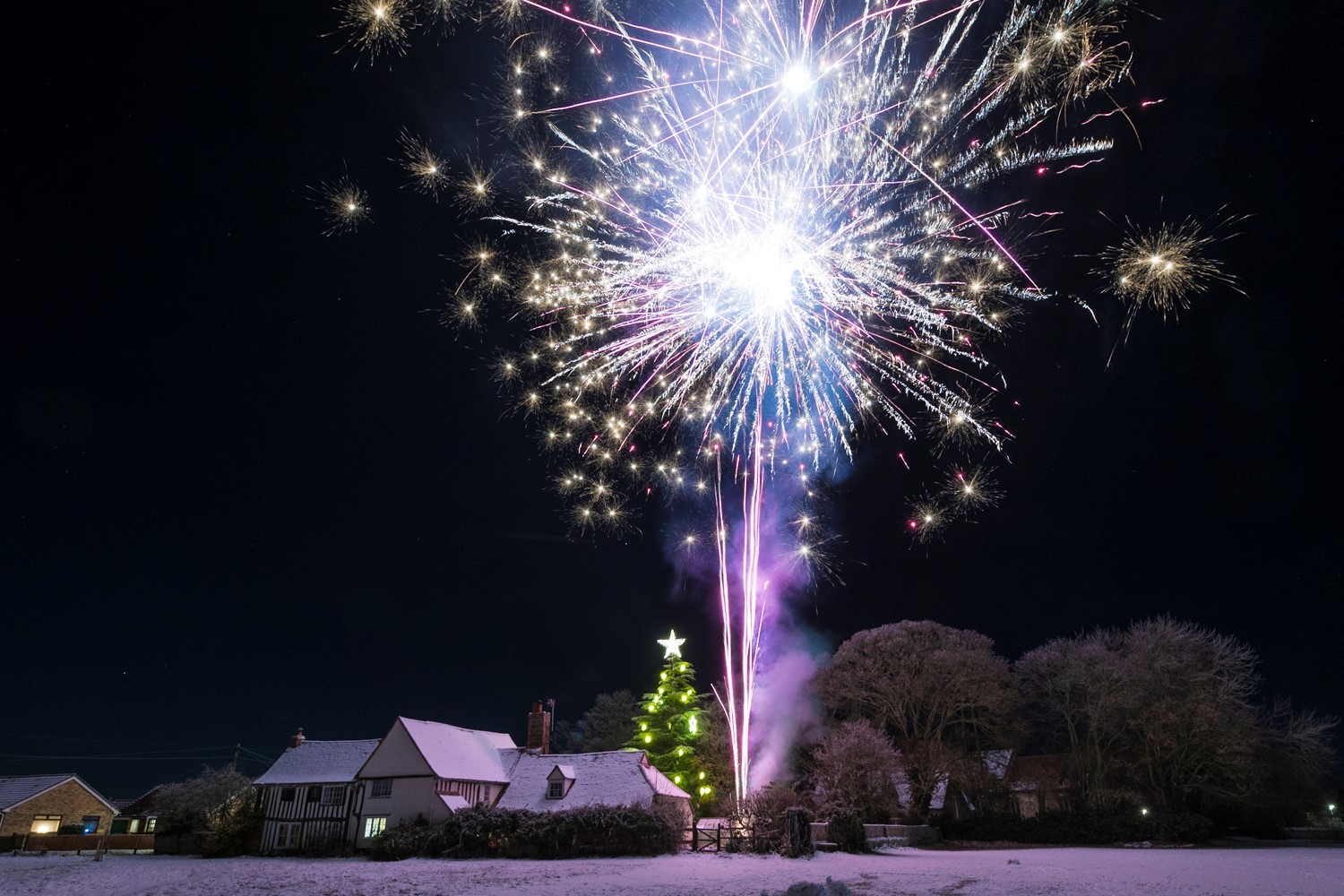 Image of previous Years Lighting the Star, with snow. taken from the Village Green toward the tree and Ian's House.